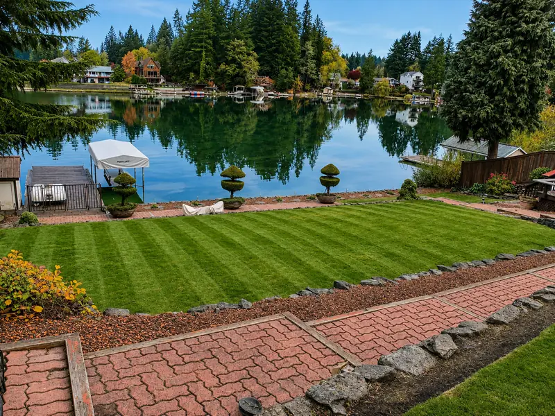 Striped waterfront lawn mowed by Marquez Landscaping in Pierce County